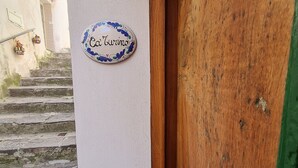 A building entrance with a sign reading "Casa Turino" and a number "15" above it. - Cozy property on the Amalfi Coast close to the most beautiful beaches (Raito)