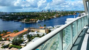 A high-rise building with a view of a river and city skyline. - 5-star Condo at The W Residences 1BR by Oneluxstay (Fort Lauderdale)