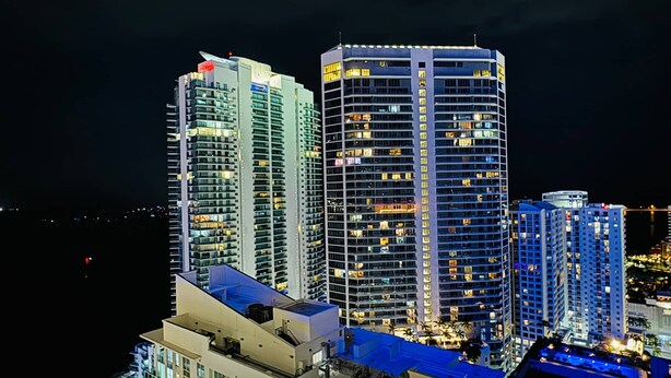 A high-rise hotel with multiple floors, large windows, and a modern architectural design. - Modern 1BR At Brickell Bay Club by Oneluxstay (Miami)