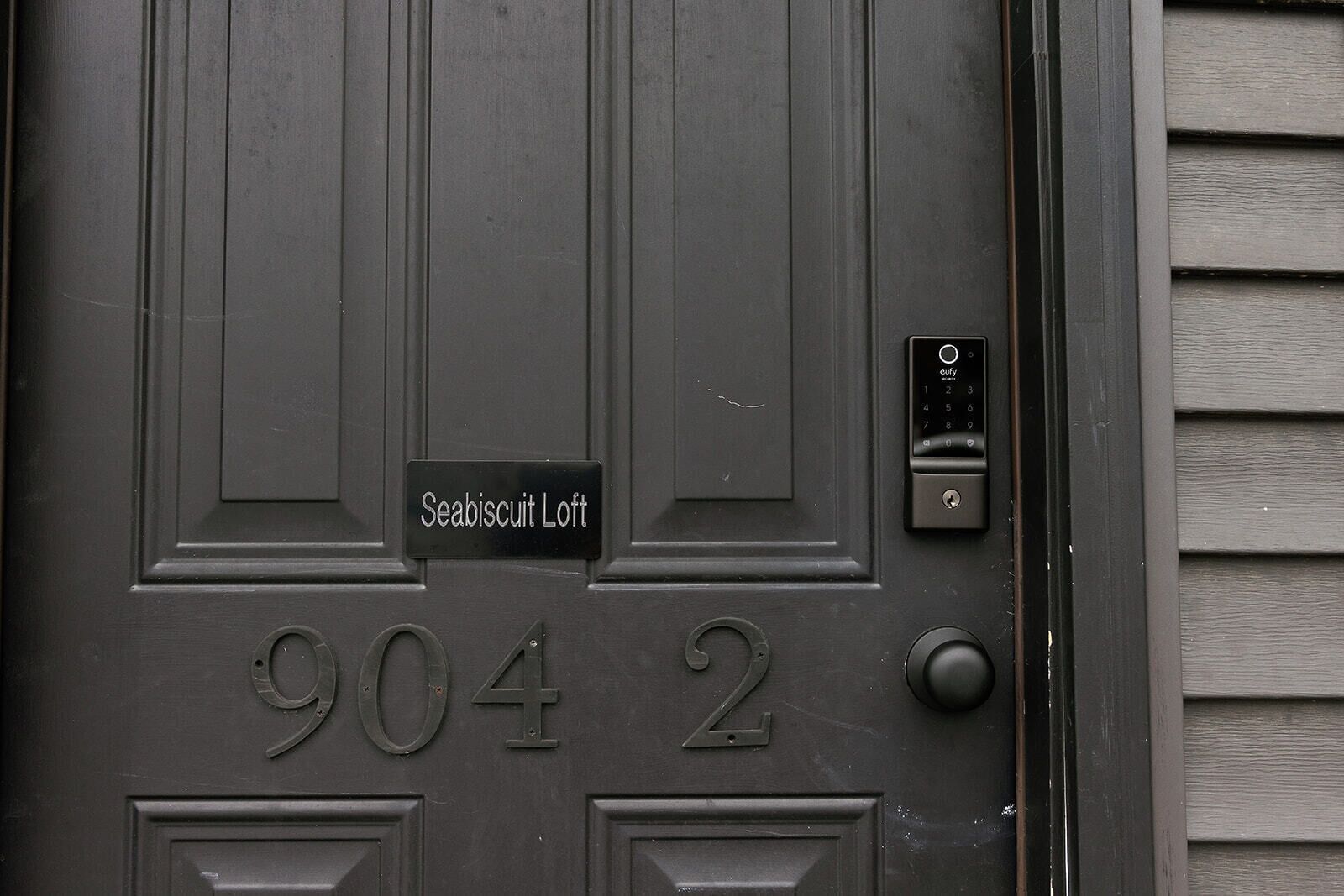 A door with the number 9042 and a sign reading "Seabiscuit Loft".