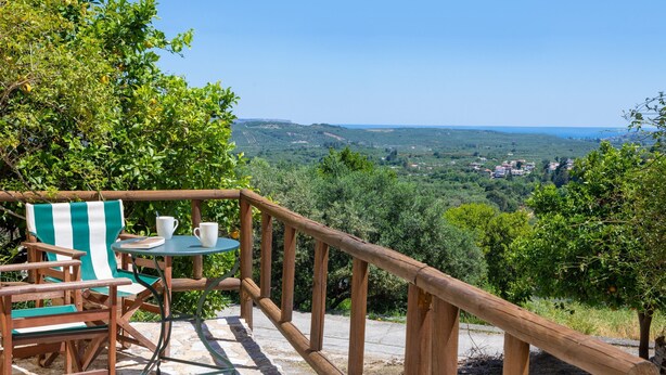 A wooden deck with a table and chairs, overlooking a scenic landscape. - Villa Erontas Mini Pool and Heated Jacuzzi (Apokoronas)