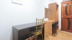 A room with a desk, a chair, a wardrobe, and a door. - RedDoorz @ Nick Hotel Isabela (Alicia)