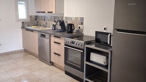 A modern kitchen with stainless steel appliances, a dishwasher, and a built-in oven. - House Rustrel between Ochres and lavenders 3 bedrooms (Rustrel)