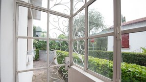 A view through a window with decorative metal bars, a stop sign, and greenery outside. - Villa Ada in Toscolano-maderno (Toscolano Maderno)