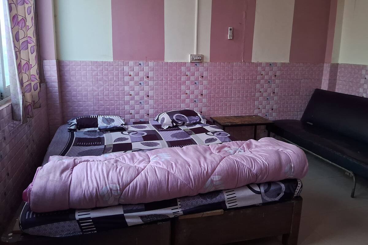 A room with a bed, a small table, and a couch.