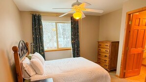A bedroom with a bed, a nightstand, a dresser, a ceiling fan, and a window with curtains. - 3/3 Townhome in Fraser just steps from the Black line! (Granby)