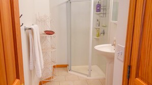 A bathroom with a shower, toilet, sink, and towel rack. - 3/3 Townhome in Fraser just steps from the Black line! (Granby)