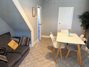 Living and dining area with sofa seating at The Grimsby Quarters.