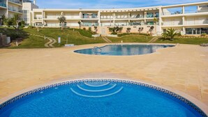 A resort with a central swimming pool, multiple balconies, and a well-maintained lawn. - Balaia Residence 2 Bedroom Penthouse With Pool (Albufeira)