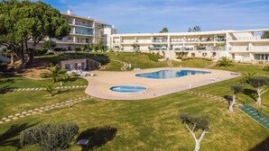 A hotel with a pool area, multiple balconies, and a well-maintained lawn. - Balaia Residence 2 Bedroom Penthouse With Pool (Albufeira)