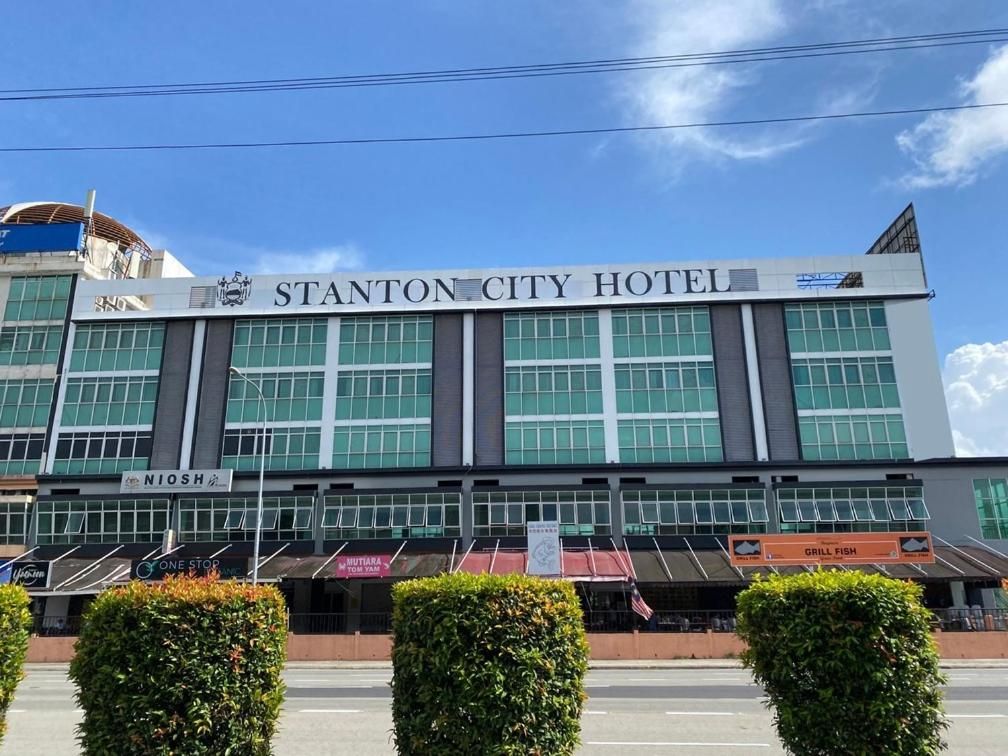 A modern hotel building with a prominent sign reading 'STANTON CITY HOTEL.'