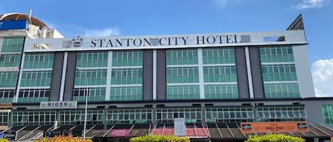 A modern hotel building with a prominent sign reading 'STANTON CITY HOTEL.'