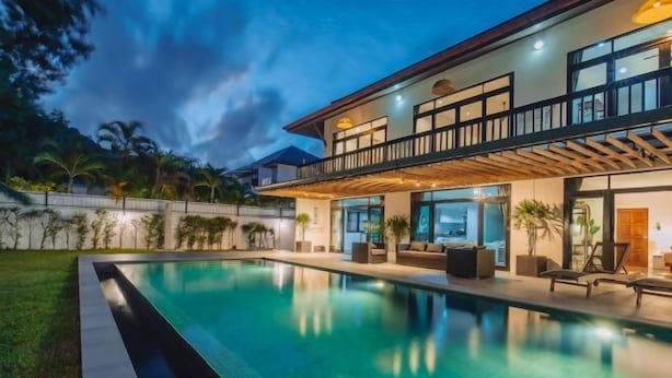 A modern house with a swimming pool, a balcony, and a well-maintained garden. - Eden Villa A Tropical Paradise Pool Villa (Phuket)