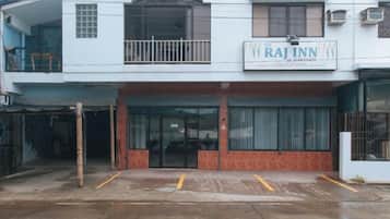A two-story building with a sign for 'Raj Inn' on the upper level.