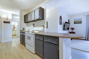 Enjoy cooking in this well-equipped kitchen with a central island, oven, and dishwasher.
