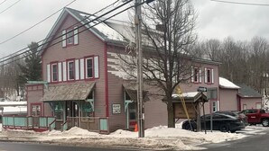 A two-story building with a 'Country Store' sign, a 'Breakfast' sign, and a 'Lunch' sign.