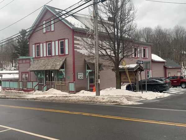 A two-story building with a 'Country Store' sign, a 'Breakfast' sign, and a 'Lunch' sign.