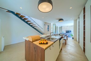 Enjoy cooking in this well-equipped kitchen with a central island, sink, and ample dining space.