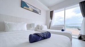 A hotel room with two beds, a large window with a view, and a painting on the wall. - Paradise Perch Tanjung Aru Inifnity Pool 2BR (Kota Kinabalu)