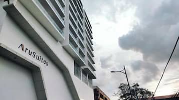 A hotel building with the name 'AruSuites' on its facade.
