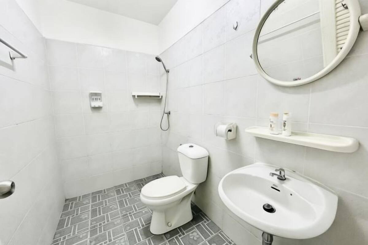 A modern bathroom with a toilet, sink, and shower.