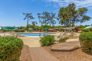 A pool area with lounge chairs, umbrellas, and a clear view of the surrounding landscape. - CASA RANCHERO: Cowboy up, golf course view. (Phoenix, Arizona)
