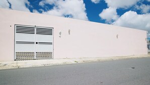 A building with a large metal gate and a flat facade.
