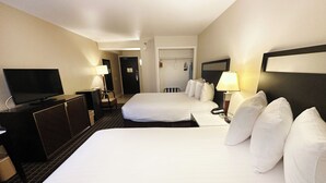 A hotel room with two beds, a TV, a desk, and a chair. - Alhambra Hotel (Alhambra)