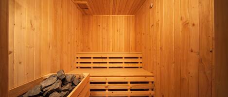 A sauna with wooden walls and benches.