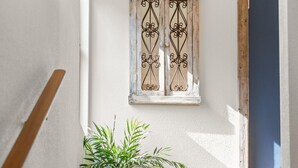 A wooden staircase with a potted plant on a small table at the top. - Cozy, comfortable, peaceful, unique lakeside house w beautiful views/Olympia (Lacey)