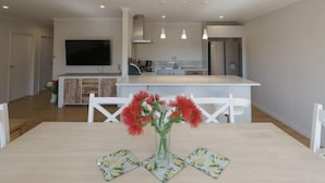 A modern kitchen with a central island, white cabinetry, and pendant lighting. - Jero Apartment (Lake Tekapo)
