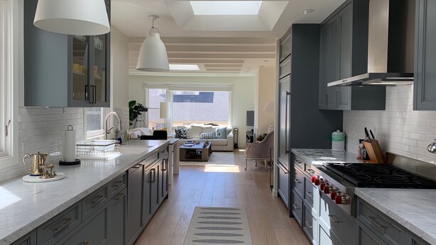 A modern kitchen with grey cabinets, a large island, and a skylight. - Sunny 3 Bedroom -Best San Francisco Neighborhood-Roofdeck w. Epic Views (San Francisco)