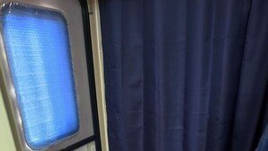 A compact bathroom with a toilet, a small window, and a shower curtain. - Cozy RV in peaceful Sandia with WiFi, AC,Lake Corpus Chrisit Access nearby (Sandia)