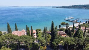 A coastal town with Mediterranean-style houses, a marina, and a clear view of the sea.