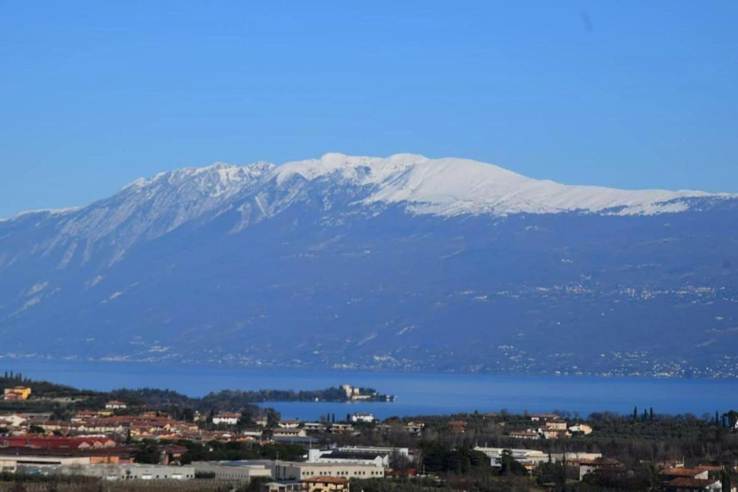 A coastal town with a mountain in the background.