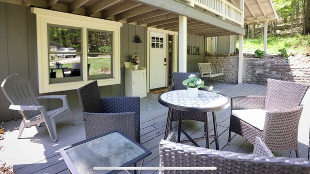 A covered outdoor patio with wicker furniture, a round table, and a view of the backyard. - Peaceful, relaxing, family friendly, fully updated 3-bedroom house in Bellville (Bellville)