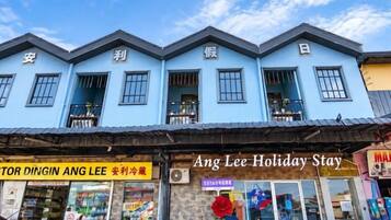 A blue building with a storefront labeled 'Ang Lee Holiday Stay.'