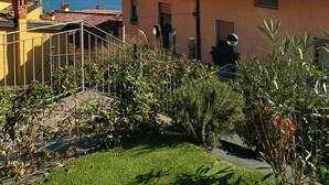 A residential area with terracotta-roofed houses, a clear blue sky, and mountains in the background. - BLONDIE HOUSE (Fonteno)