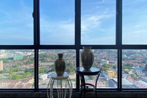A view through a window with two vases on a white stool and a small table. - The Pines by Amanjiwa (Melaka)