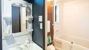 A bathroom with a mirror, sink, and shower. - Shishinkaku (Kyoto)