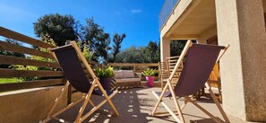 An outdoor seating area with two folding chairs, a sofa, and potted plants. - T2 Peaceful neighborhood Vigna Majo, Olmeto (Olmeto)