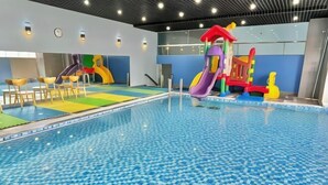 An indoor swimming pool with a colorful play area, including slides and climbing structures. - 3-bedroom Oasky Vung Tau with Partial Ocean View (Ho Chi Minh City)