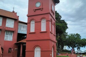 A red building with a clock tower, a sign with the number 310, and a tree in the background. - Homestay Melaka at Mahkota Hotel - Unit 3093, 2092 - Free Wifi & Parking (Melaka)