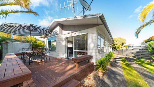 A modern house with a deck, outdoor furniture, and a satellite dish. - Westhall in Kinloch Taupo (Kinloch)