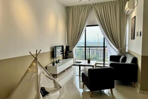 A modern living room with a sofa, a small table, a white cabinet, and a tent-like structure. - Ipoh Town Horizon Skypool Suites 4-11pax by IWH Suites (Ipoh)