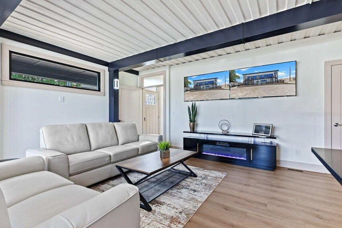 A modern living room with a sofa, coffee table, and entertainment unit.
