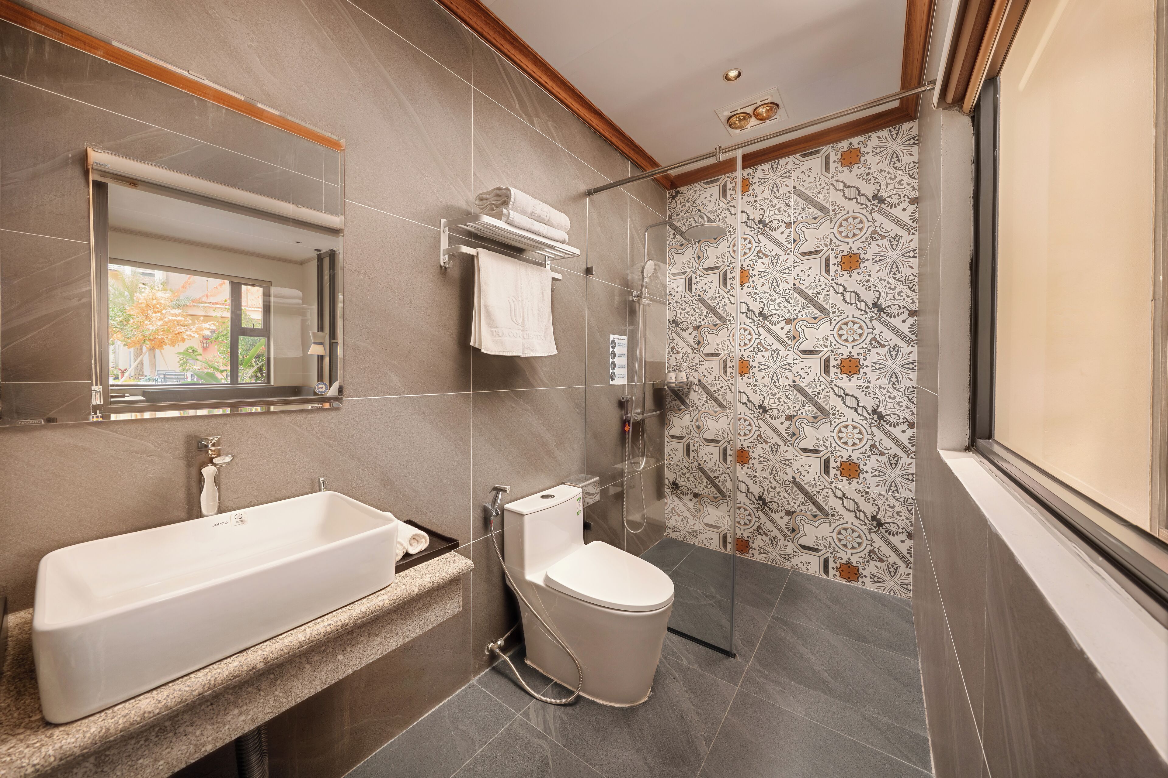 A modern bathroom with a large bathtub, a toilet, and a shower area.