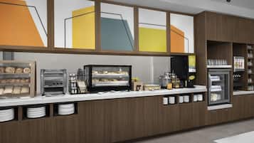 A modern breakfast bar with a coffee machine, toaster, and display case with pastries.