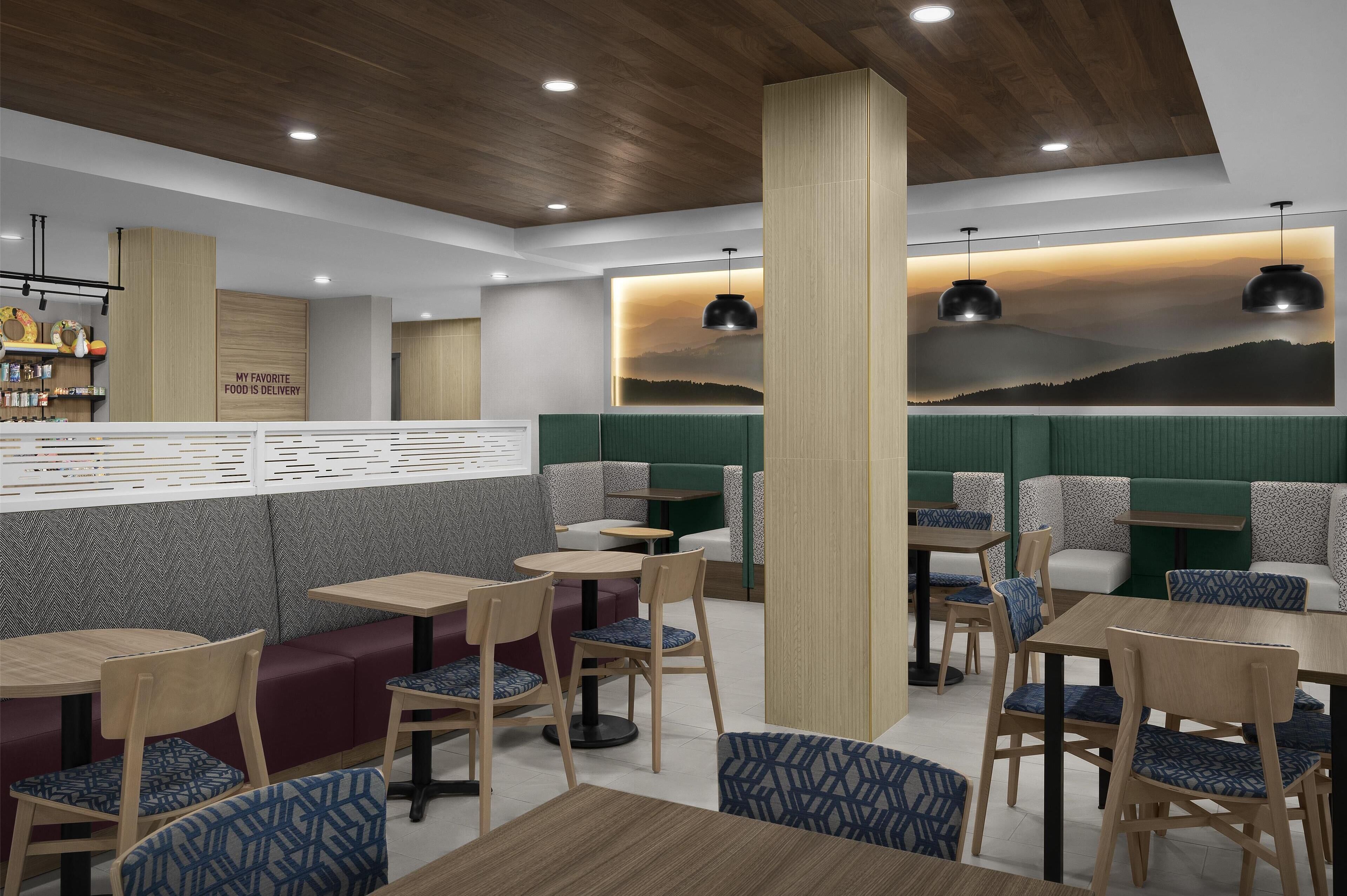 A restaurant interior with booths, tables, and a bar area.