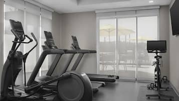 A gym with treadmills, an elliptical, and a stationary bike.